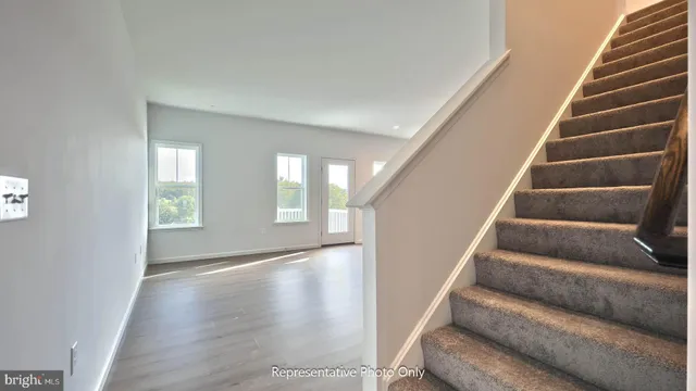 a view of an entryway with wooden floor