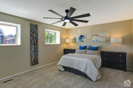 1933 Rua Branco Drive Sandy, UT 84093 - Photo 40 of 42 Room featuring two windows, neutral wall tones, and installed carpeting