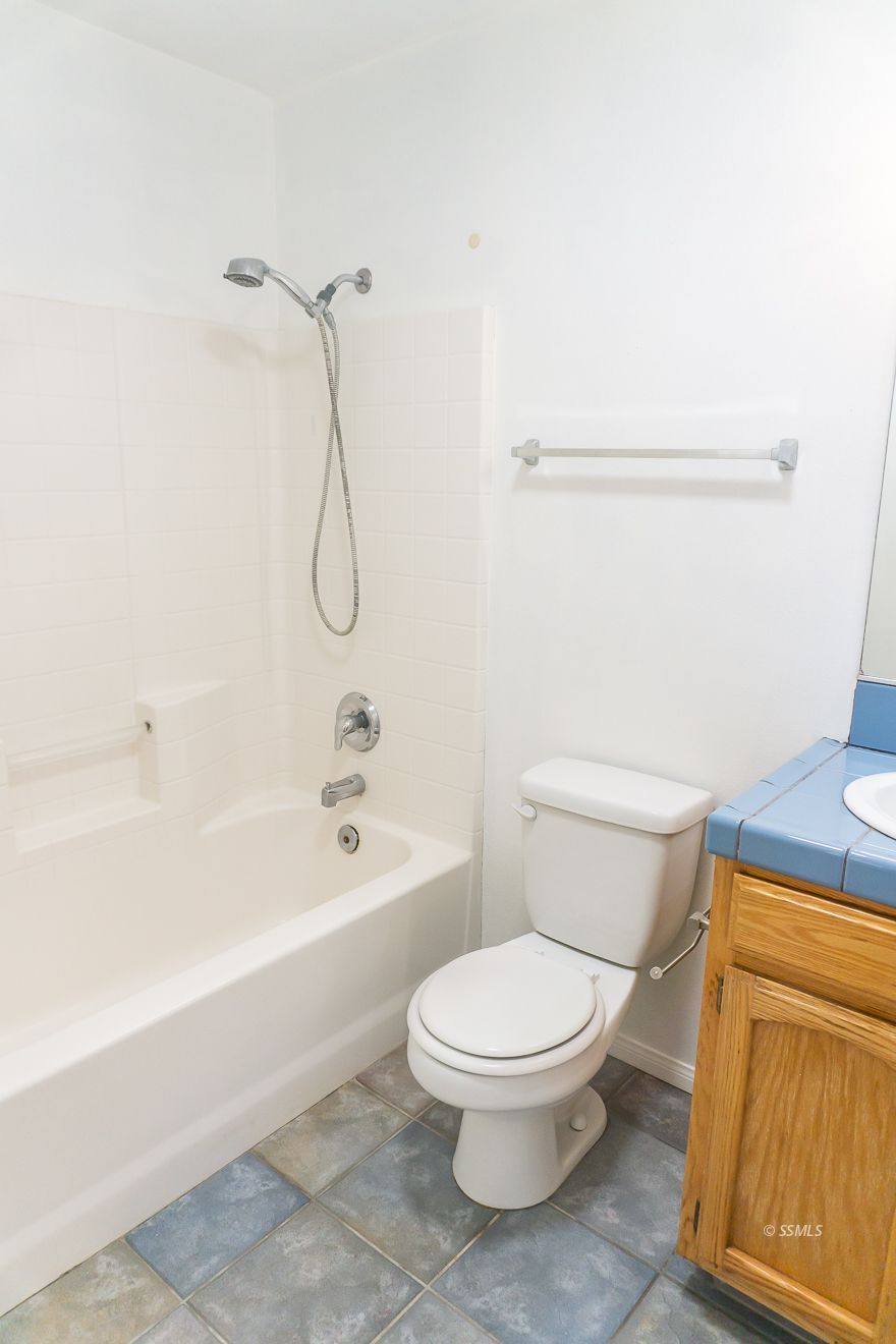 915 Sims Street Ridgecrest, CA 93555 - Photo 20 of 37 a white toilet sitting next to a bath tub