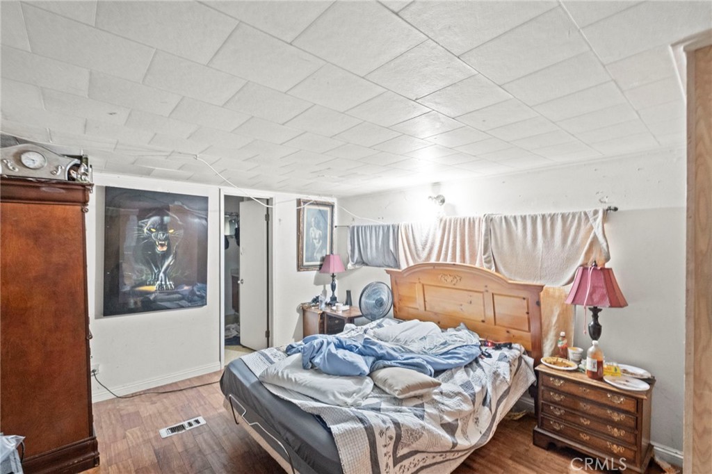 42185 Oak Canyon Road Hemet, CA 92544 - Photo 12 of 42 a bedroom with a bed and a painting on the wall