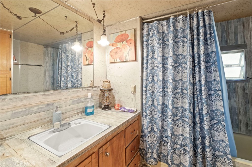 42185 Oak Canyon Road Hemet, CA 92544 - Photo 15 of 42 a bathroom with a granite countertop sink and a mirror