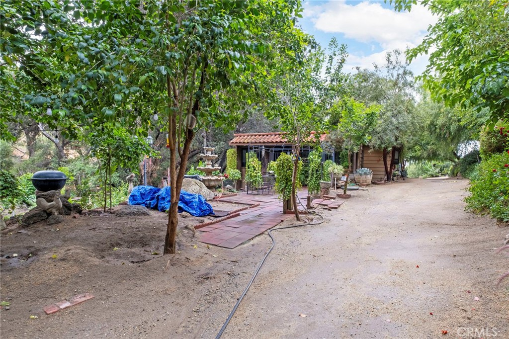 42185 Oak Canyon Road Hemet, CA 92544 - Photo 20 of 42 a view of a patio with a table and chairs under an umbrella