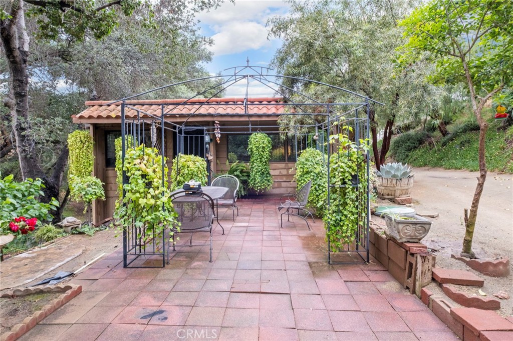 42185 Oak Canyon Road Hemet, CA 92544 - Photo 2 of 42 a patio with table and chairs and potted plants
