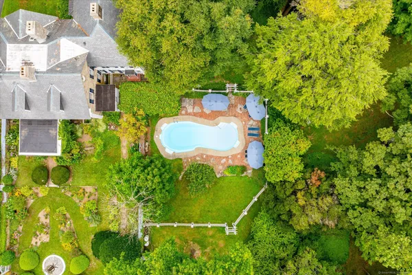 a backyard of a house with lots of green space and plants