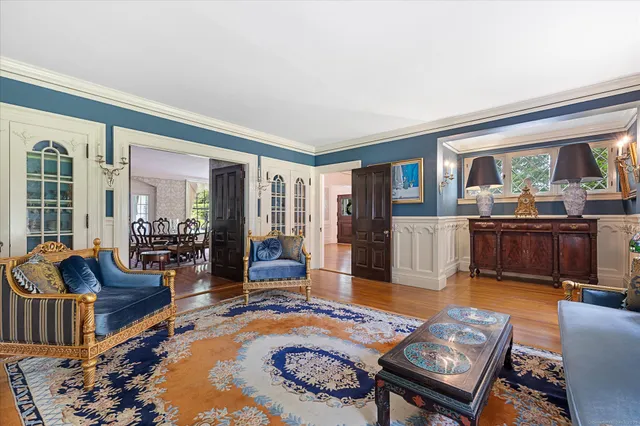 a living room with furniture fireplace and a table