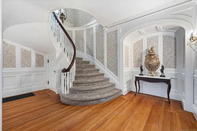 a view of a livingroom with wooden floor and furniture