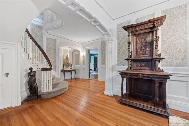 a view of an entryway and livingroom with wooden floor