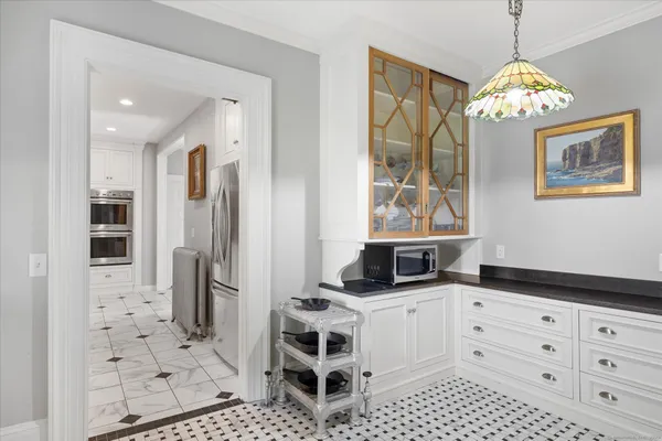 a kitchen with stainless steel appliances kitchen island granite countertop a refrigerator and a stove top oven