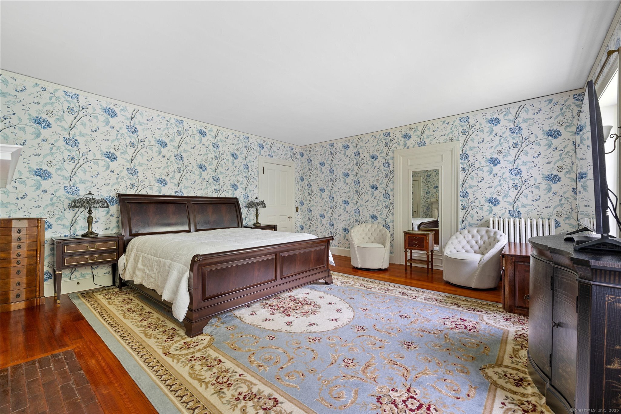 357 Wrights Crossing Road Pomfret, CT 06259 - Photo 27 of 40 a bedroom with a bed and wooden floor