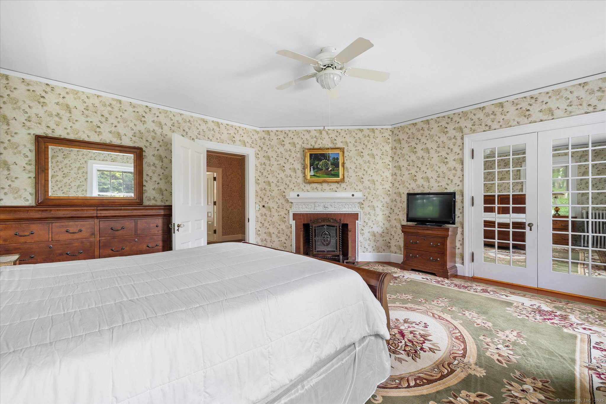 357 Wrights Crossing Road Pomfret, CT 06259 - Photo 29 of 40 a spacious bedroom with a large bed a fireplace and a window