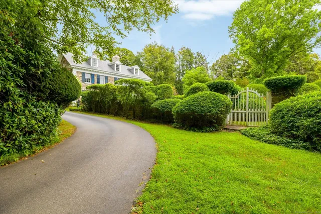a view of a garden with a house in the background