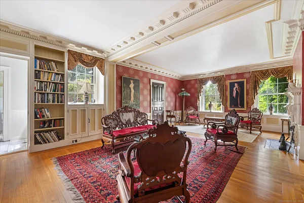 a living room with furniture and a book shelf