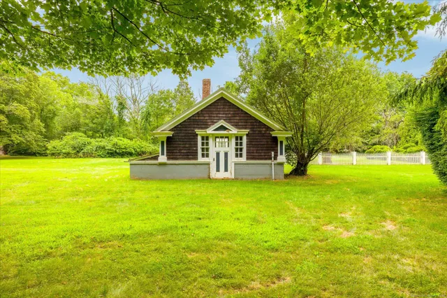 a front view of a house with yard and green space