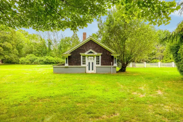 a front view of a house with yard and green space