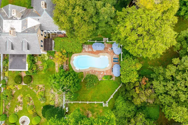 a backyard of a house with lots of green space and plants