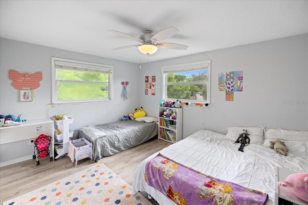 307 Winfield Way Nokomis, FL 34275 - Photo 12 of 58 a bedroom with two beds and a chandelier