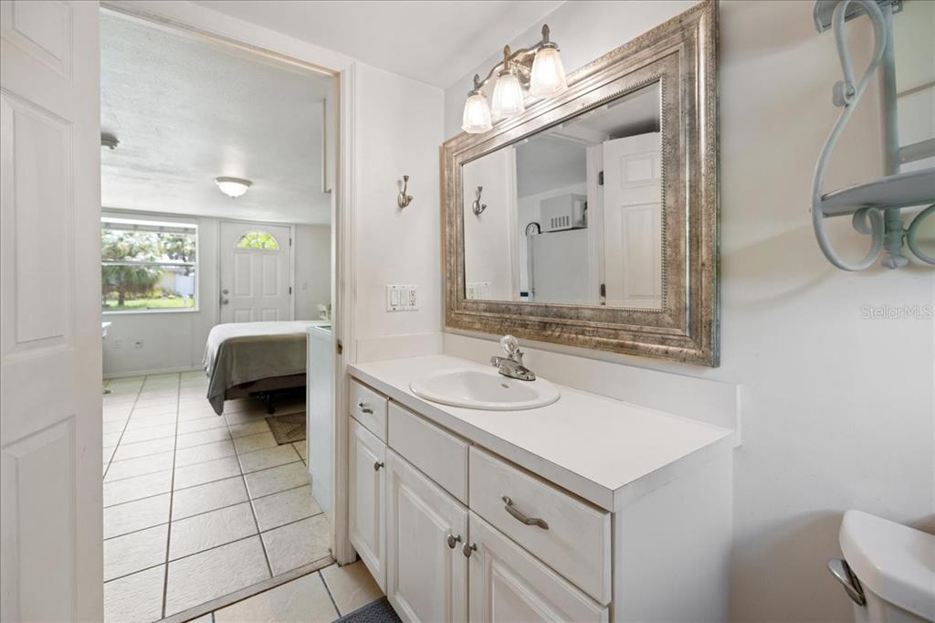 307 Winfield Way Nokomis, FL 34275 - Photo 21 of 58 a en suite bathroom with a double vanity sink a mirror and a shower