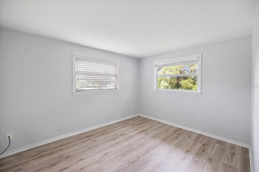 307 Winfield Way Nokomis, FL 34275 - Photo 28 of 58 a view of an empty room with wooden floor and a window
