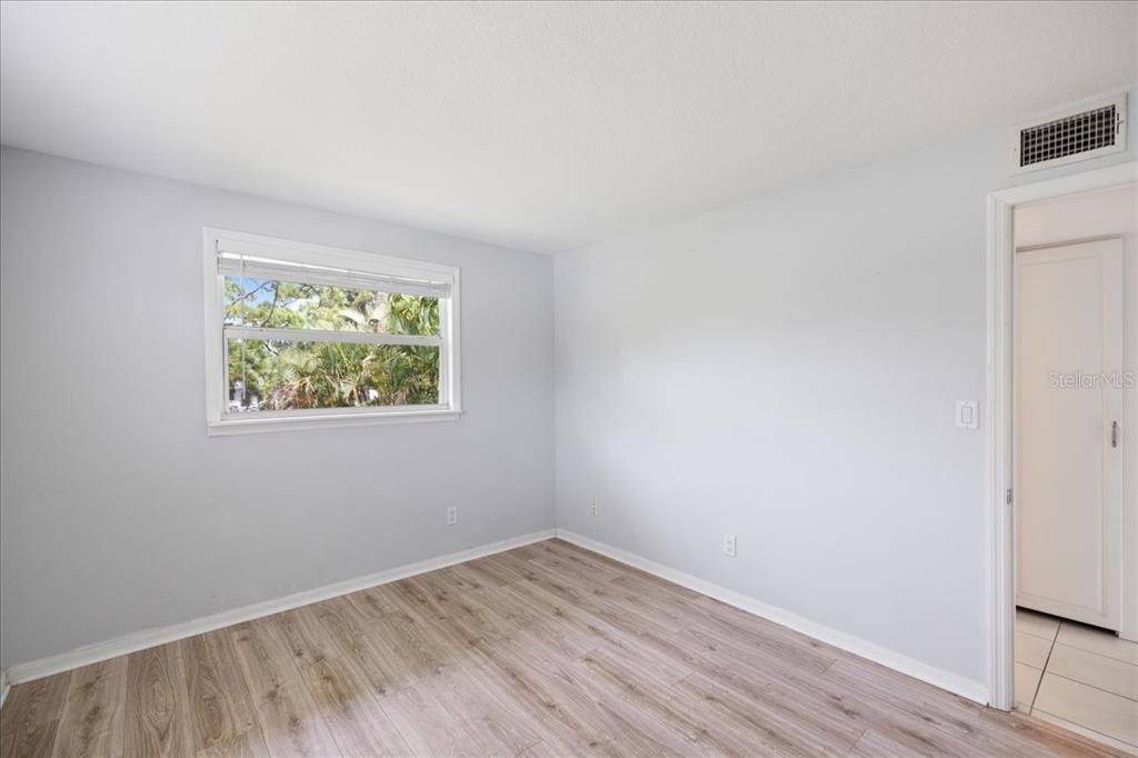 307 Winfield Way Nokomis, FL 34275 - Photo 29 of 58 an empty room with wooden floor and window