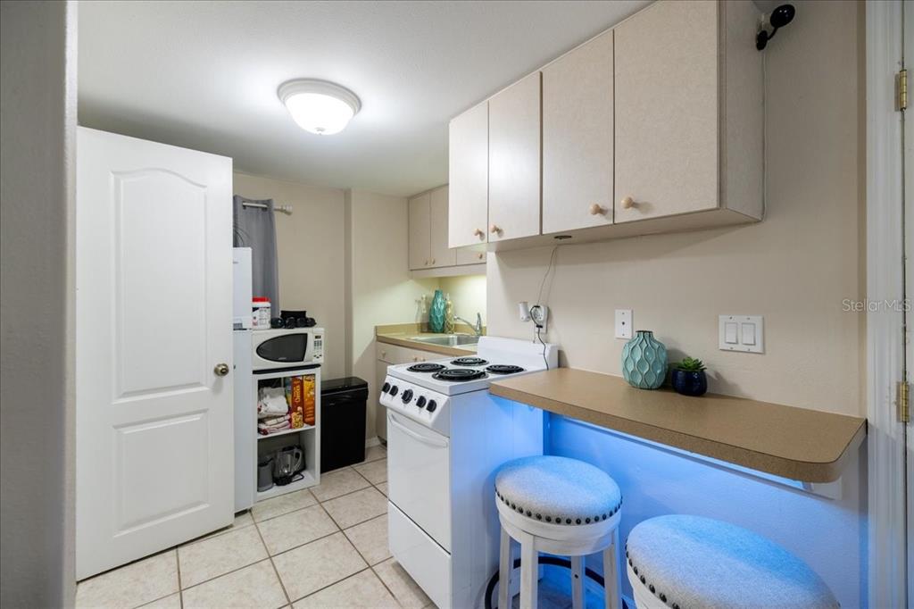 307 Winfield Way Nokomis, FL 34275 - Photo 35 of 58 a kitchen with stainless steel appliances a stove a sink cabinets and a refrigerator