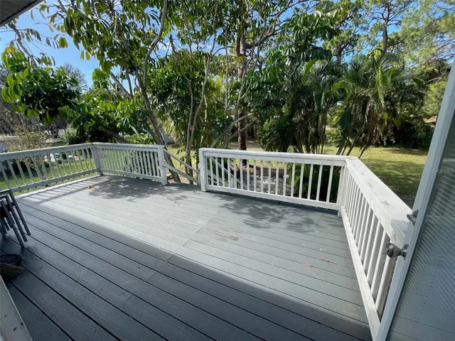 a view of a patio with table and chairs and potted plants
