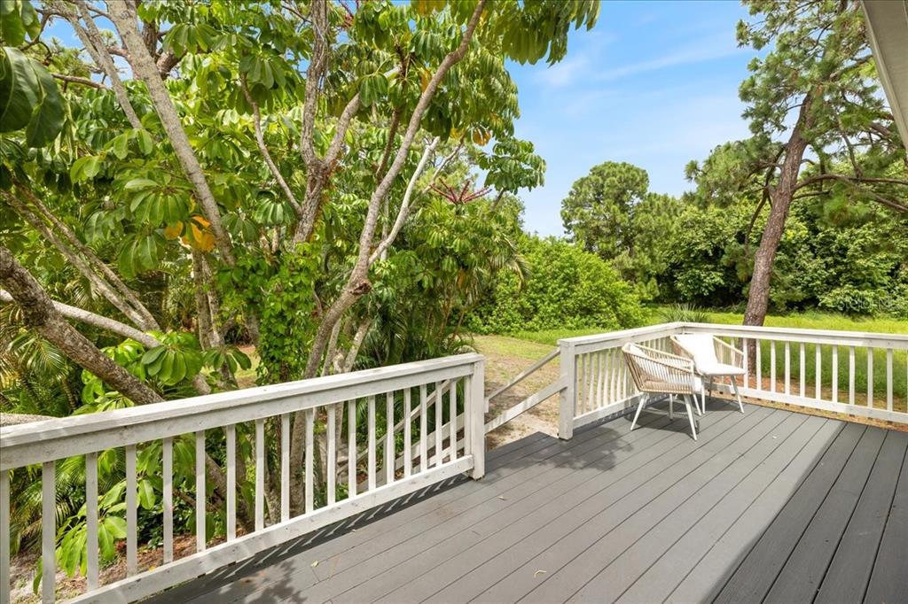 307 Winfield Way Nokomis, FL 34275 - Photo 53 of 58 a view of a deck with two chairs and wooden floor