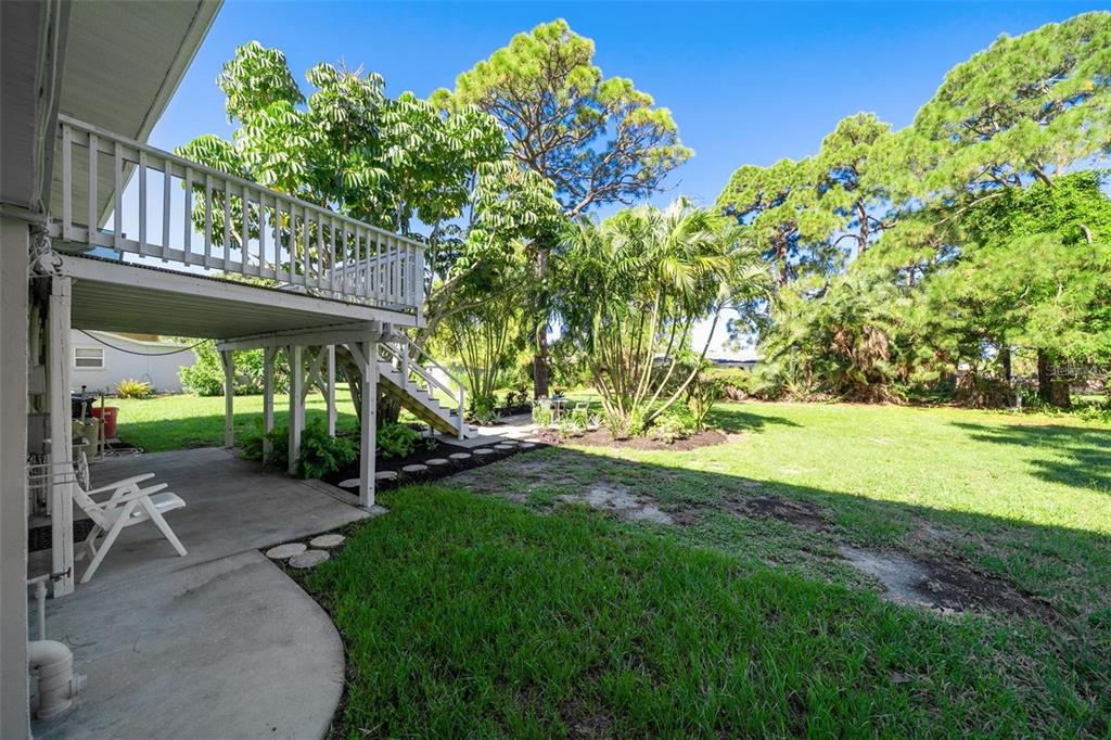 307 Winfield Way Nokomis, FL 34275 - Photo 6 of 58 a view of a patio with table and chairs and potted plants