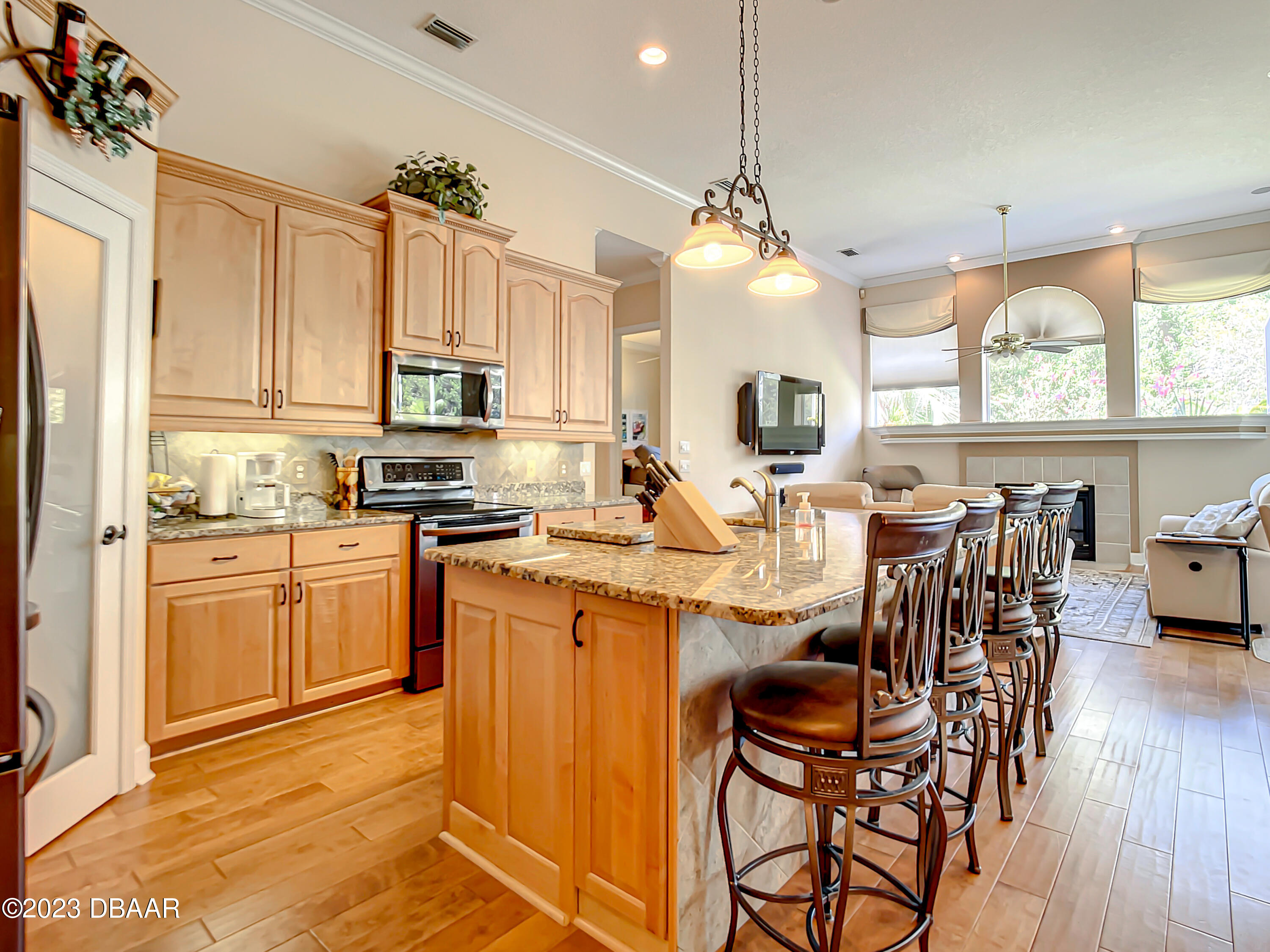 123 Deep Woods Way Ormond Beach, FL 32174 - Photo 14 of 66 a kitchen with stainless steel appliances a table chairs sink and cabinets