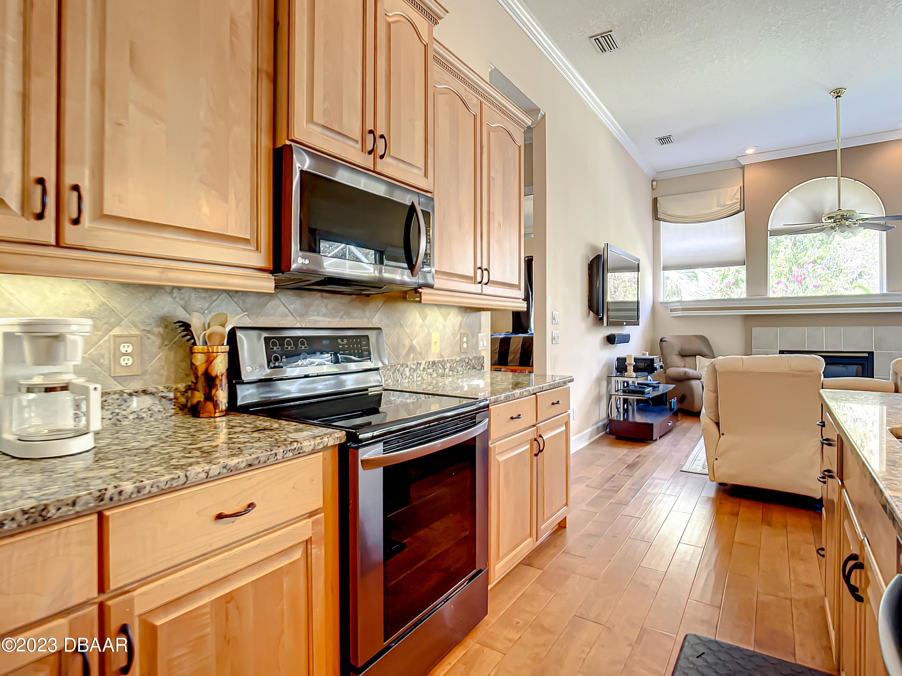 123 Deep Woods Way Ormond Beach, FL 32174 - Photo 15 of 66 a kitchen with stainless steel appliances granite countertop a stove a sink and a microwave