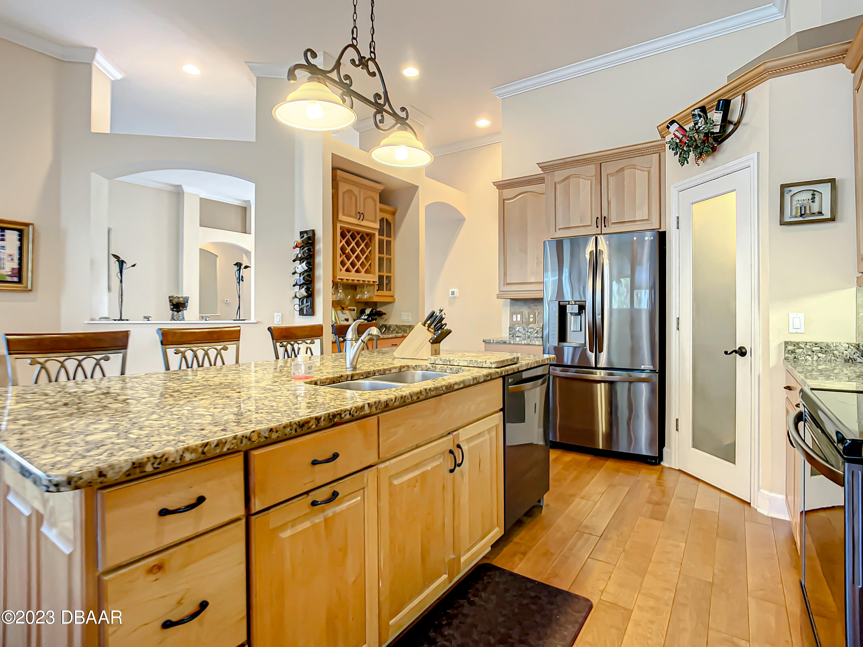 123 Deep Woods Way Ormond Beach, FL 32174 - Photo 17 of 66 a kitchen with stainless steel appliances granite countertop a refrigerator a sink dishwasher a oven with white cabinets and wooden floor