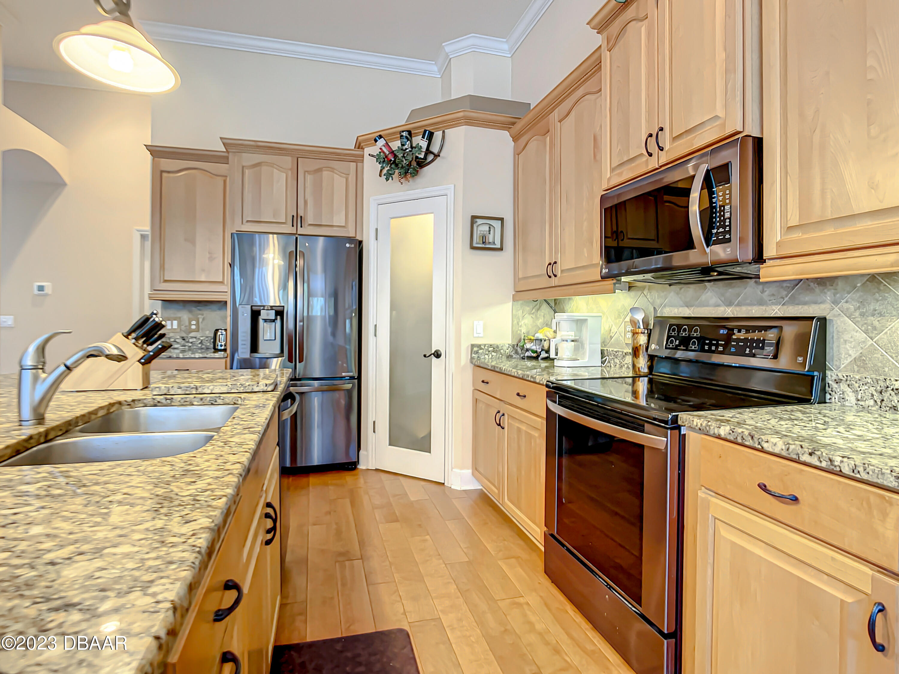 123 Deep Woods Way Ormond Beach, FL 32174 - Photo 18 of 66 a kitchen with stainless steel appliances granite countertop a sink a stove and a refrigerator