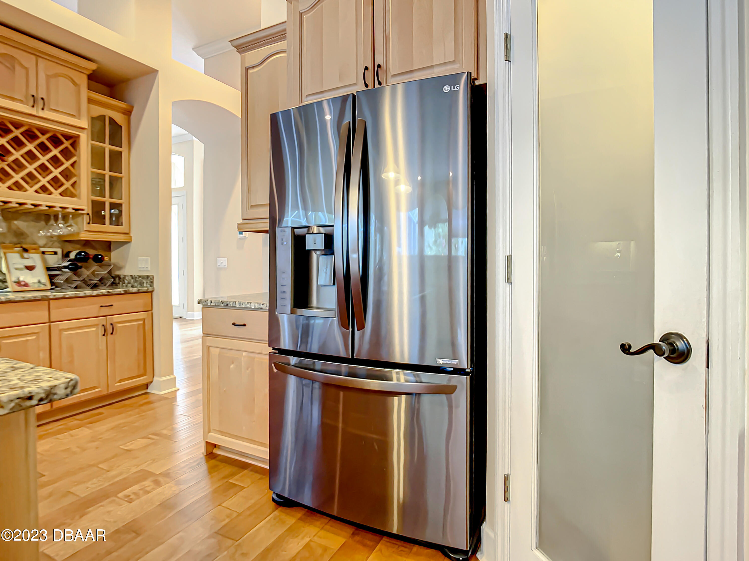 123 Deep Woods Way Ormond Beach, FL 32174 - Photo 19 of 66 a view of a refrigerator in kitchen and wooden floor