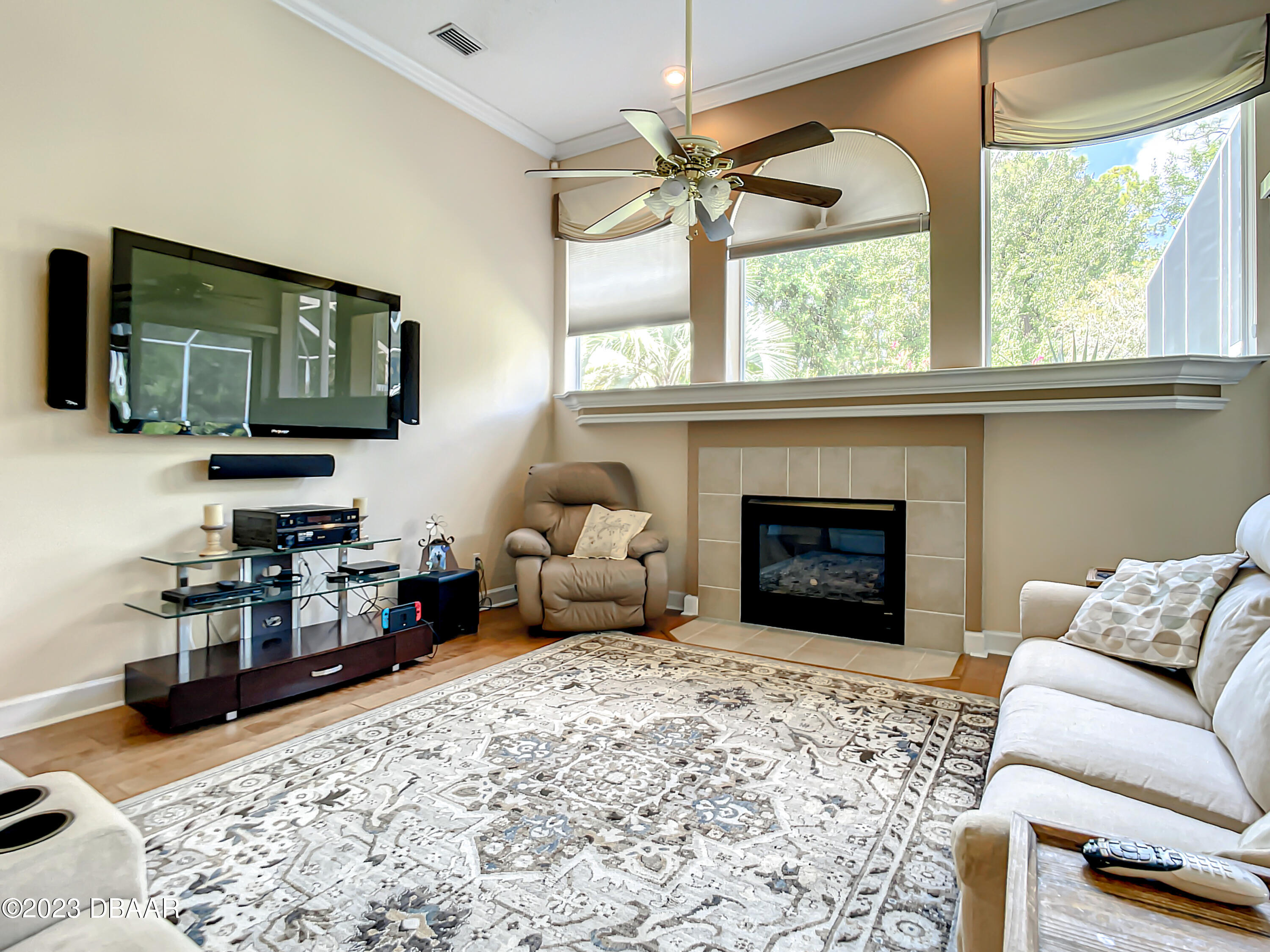 123 Deep Woods Way Ormond Beach, FL 32174 - Photo 24 of 66 a living room with furniture a fireplace and a flat screen tv