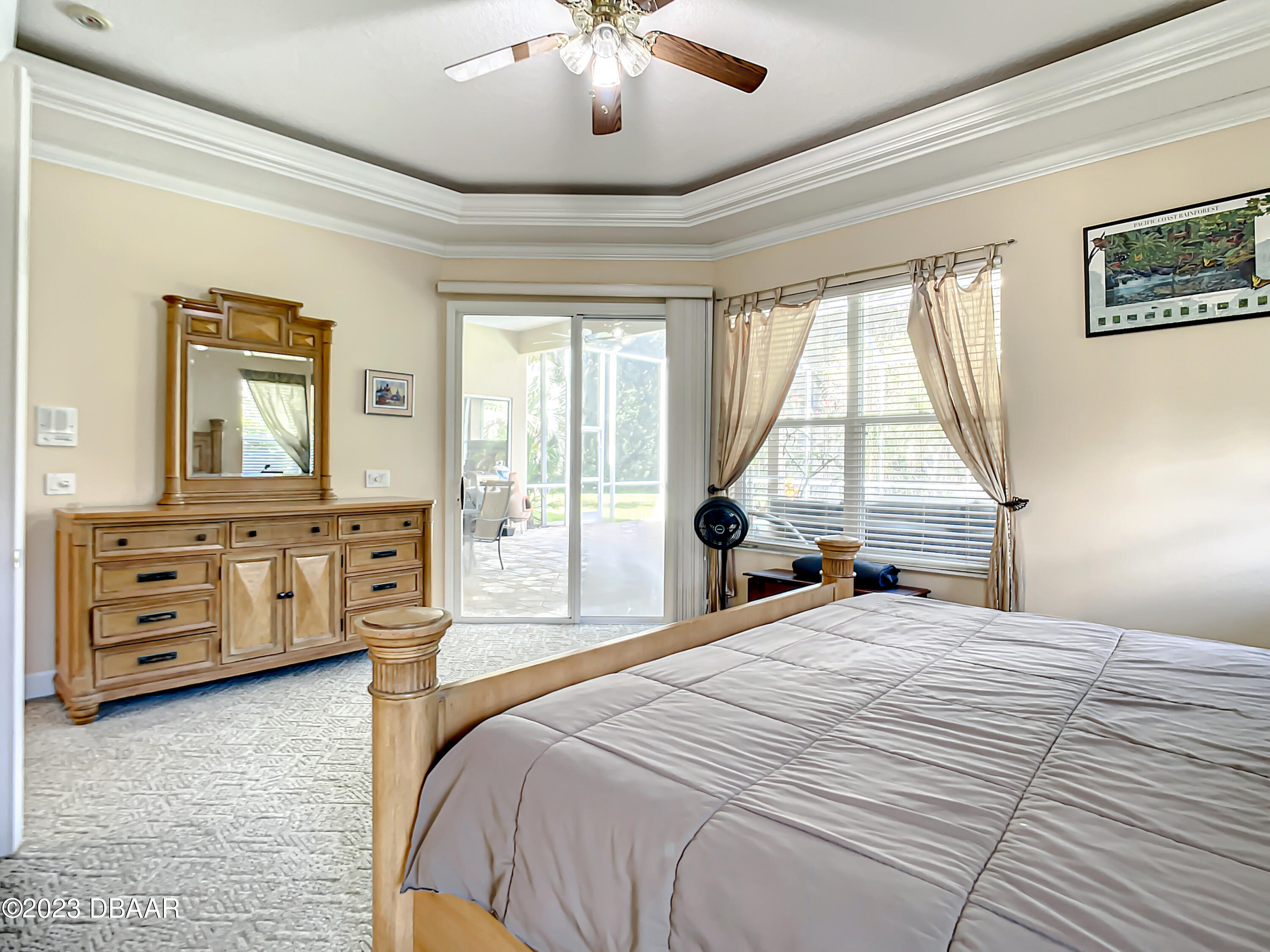 123 Deep Woods Way Ormond Beach, FL 32174 - Photo 30 of 66 a bedroom with a bed a dresser and next to a window