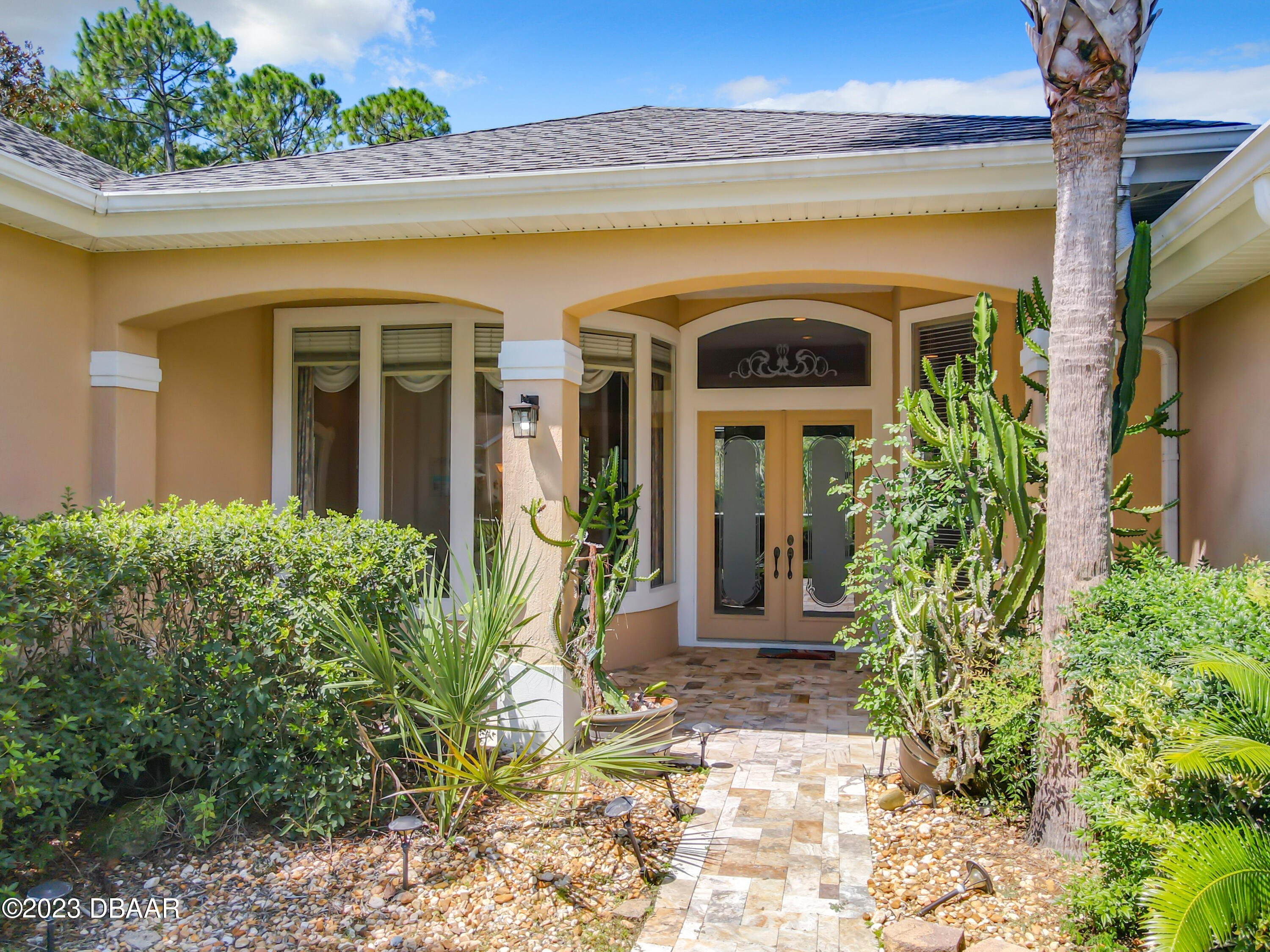123 Deep Woods Way Ormond Beach, FL 32174 - Photo 3 of 66 a front view of a house with garden