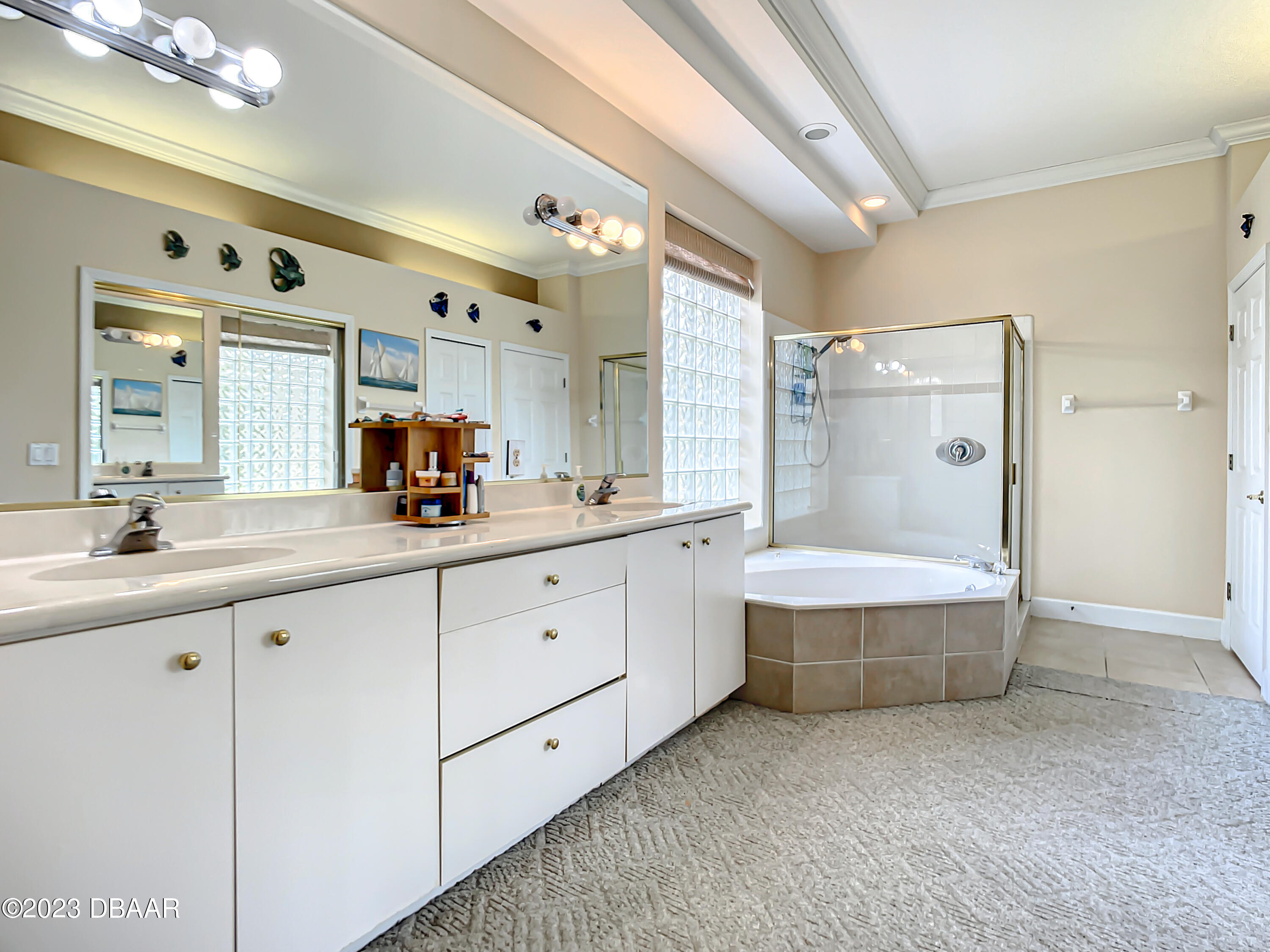 123 Deep Woods Way Ormond Beach, FL 32174 - Photo 31 of 66 a spacious bathroom with double vanity a mirror a bathtub and a shower