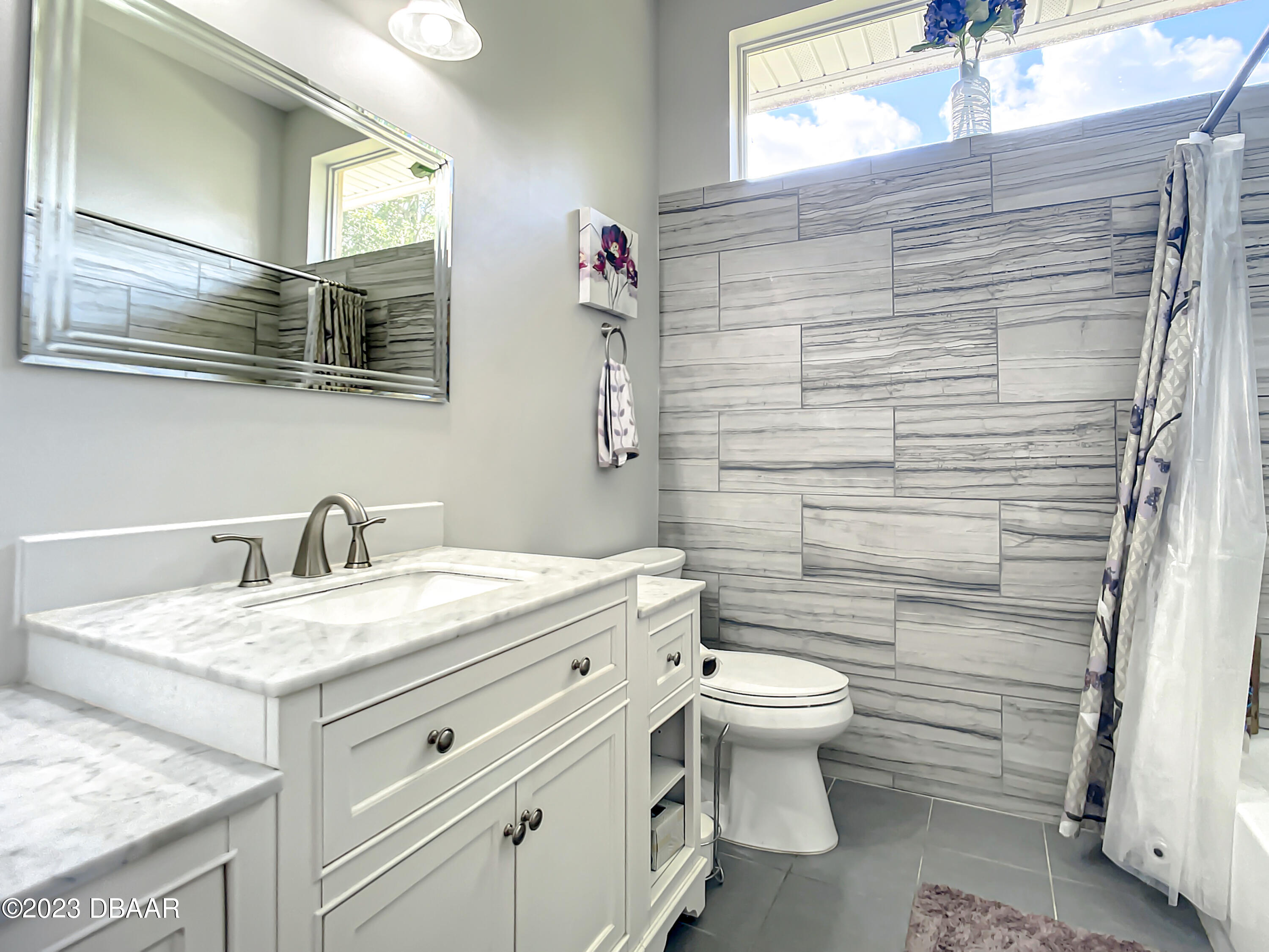 123 Deep Woods Way Ormond Beach, FL 32174 - Photo 34 of 66 a bathroom with a granite countertop toilet sink and mirror