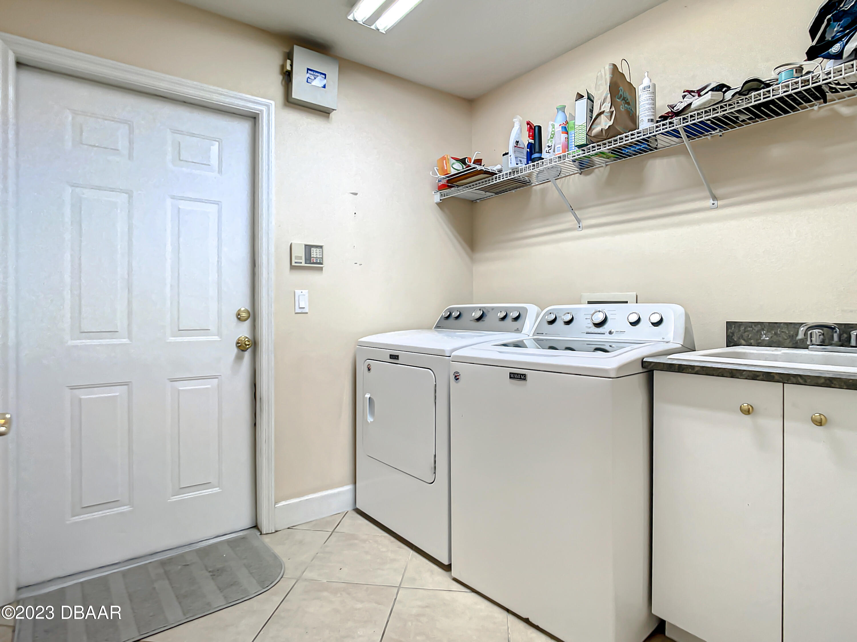 123 Deep Woods Way Ormond Beach, FL 32174 - Photo 47 of 66 a utility room with sink dryer and washer