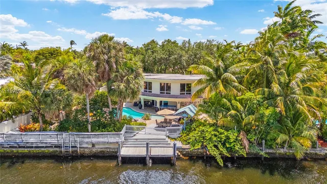 a view of house with swimming pool yard and outdoor seating
