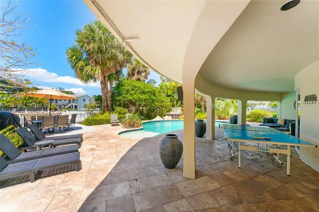 a living room with patio furniture and a garden