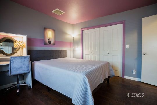 312 East Upjohn Avenue Ridgecrest, CA 93555 - Photo 24 of 35 a bedroom with a bed and wooden floor
