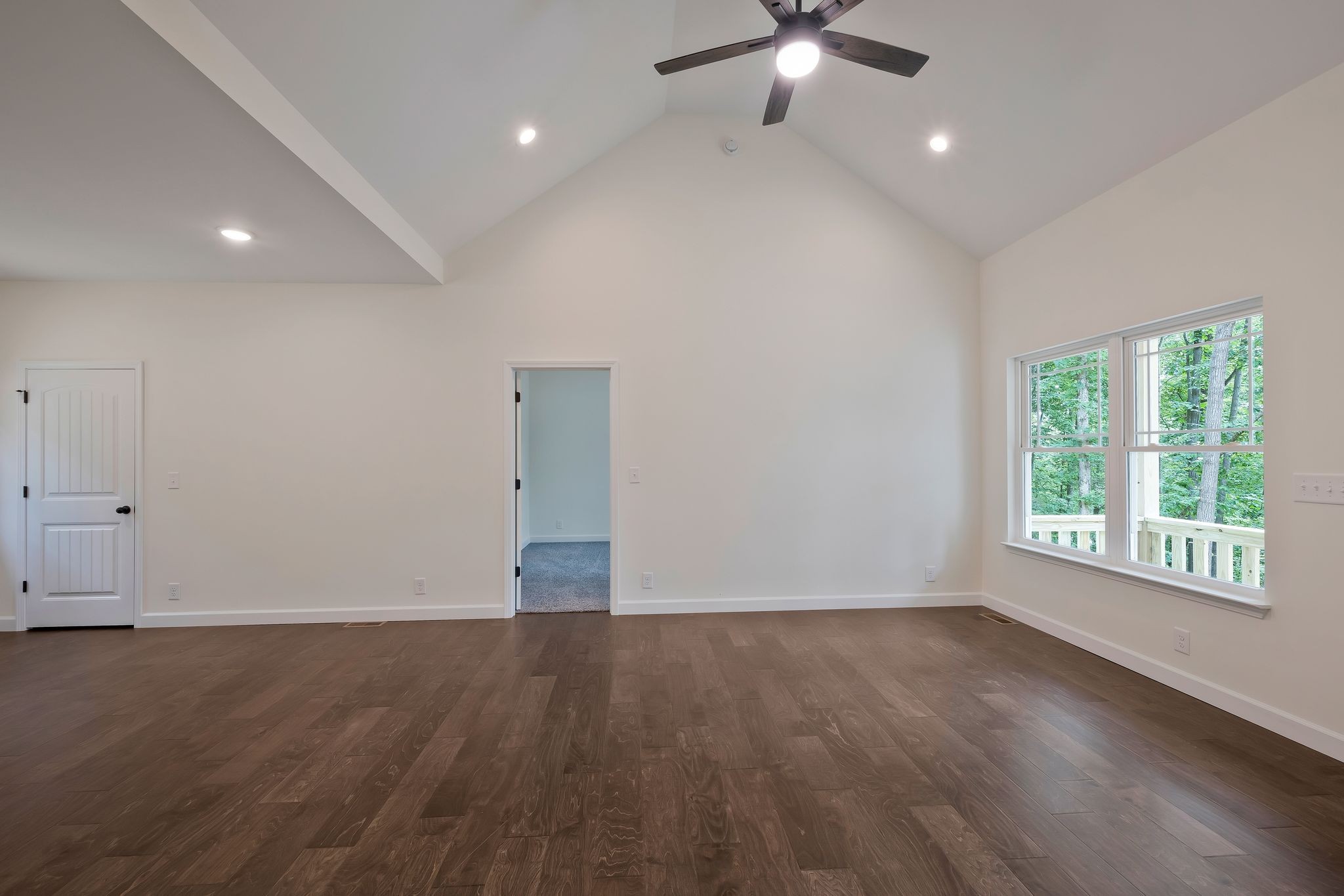 845 Lucas Road Dickson, TN 37055 - Photo 9 of 31 an empty room with wooden floor chandelier fan and windows