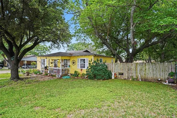 a view of a house with a yard and sitting area