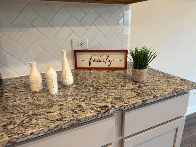 a view of a kitchen with wooden floor and a kitchen island