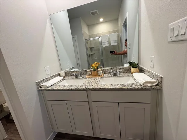 a bathroom with a shower and a glass door shower