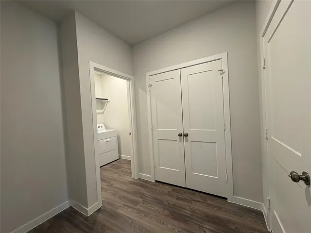 a view of a room with wooden floor