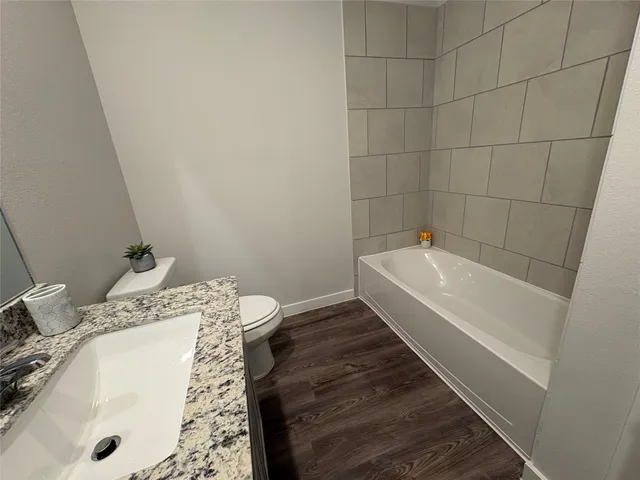 a bathroom with a tub and sink