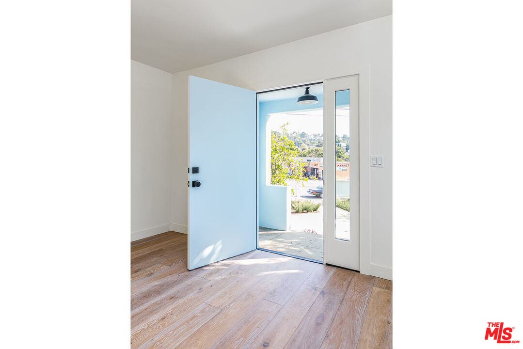 3375 Eagle Rock Boulevard Los Angeles, CA 90065 - Photo 3 of 12 a view of a hallway with wooden floor and a bathroom