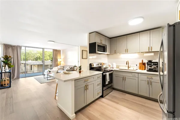 a kitchen with a sink stove and cabinets