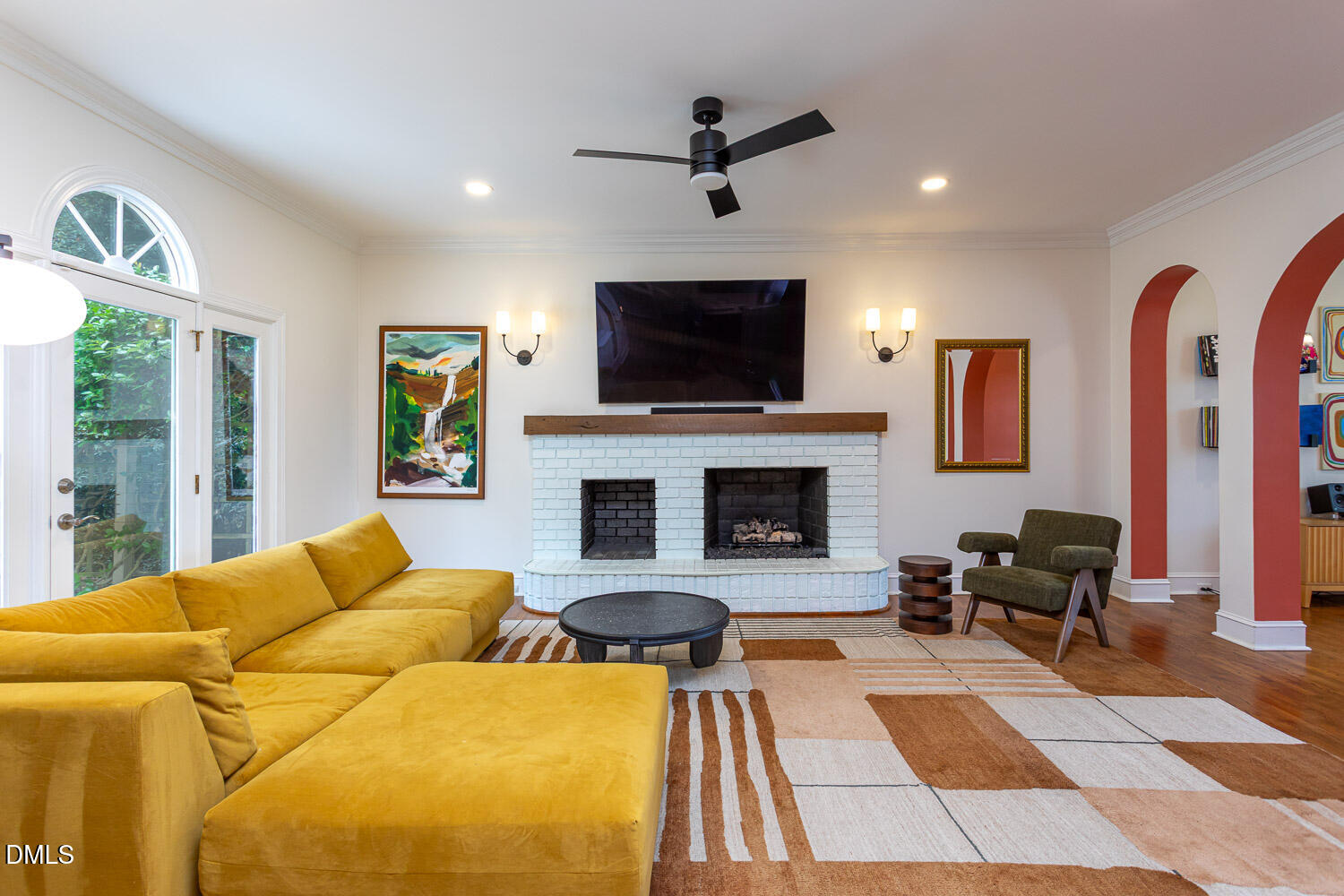 8509 Towneley Place Raleigh, NC 27615 - Photo 8 of 36 a living room with furniture a flat screen tv and a fireplace